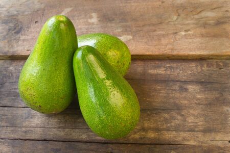 avocado on wood backgroundの写真素材