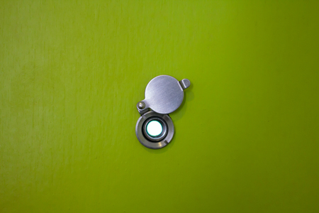 door lens peephole on green wooden textureの写真素材