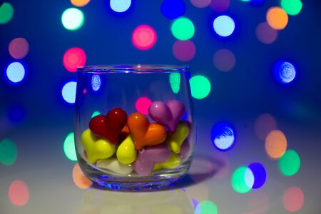 Multicolor heart shape in glass with bokeh backgroundの写真素材