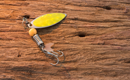 Fishing hook on wood backgroundの写真素材