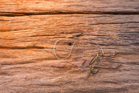 Fishing hook on wood backgroundの写真素材