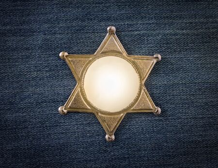Wild West Sheriff badge on denim backgroundの写真素材