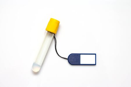Blank tag label and test tube on white backgroundの写真素材