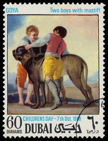 DUBAI - CIRCA 1968  a stamp printed by Dubai shows a picture of artist Goya  Two boys with mastiff , circa 1968 のeditorial素材