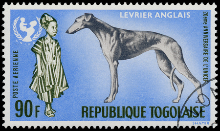 TOGO - CIRCA 1967: A stamp printed by Togo, shows The 20th Anniversary of UNICEF and Greyhound dog - Levrier Anglais, circa 1967 のeditorial素材