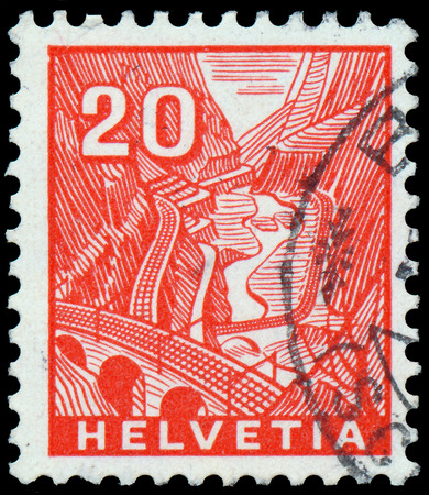 SWITZERLAND - CIRCA 1934: A stamp printed in Switzerland shows train track to Railway St Gothard, circa 1934の写真素材
