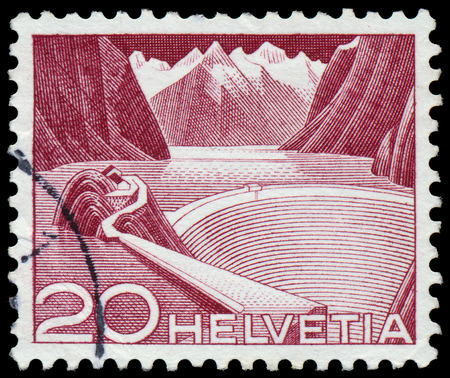 SWITZERLAND - CIRCA 1949: A stamp printed in Switzerland shows Grimsel Reservoir, circa 1949. の写真素材