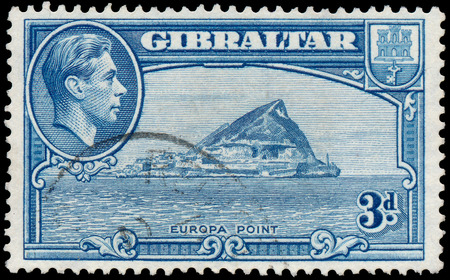 GIBRALTAR - CIRCA 1938: A stamp printed in GIBRALTAR shows image of the George VI (Albert Frederick Arthur George) was King of the United Kingdom and the Dominions of the British Commonwealth, circa 1938.のeditorial素材