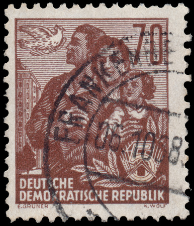 DDR - CIRCA 1955: A stamp printed in DDR, shows a family, series Five-year plan, circa 1955のeditorial素材
