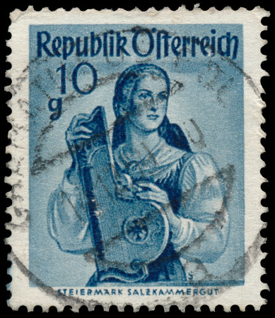 AUSTRIA - CIRCA 1949: a stamp printed in the Austria shows Woman from Steiermak, Salzkammergut, Regional Costume, circa 1949のeditorial素材