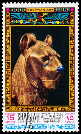 SHARJAH - CIRCA 1968: Stamp printed Sharjah shows a golden lion's head, a series devoted to the treasures of ancient Egyptian art, circa 1968のeditorial素材