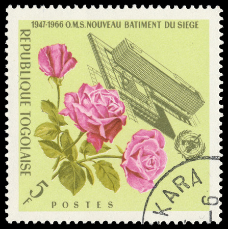 BUDAPEST, HUNGARY - 21 february 2016: a stamp printed in the Togo shows Headquarters of W.H.O. with flowers, circa 1966のeditorial素材