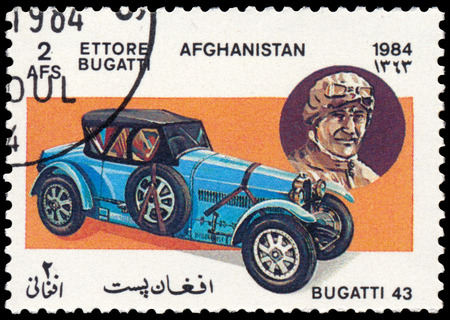 BUDAPEST, HUNGARY - 18 march 2016:  a stamp printed in Afghanistan shows car Bugatti Type 43 (1927) and portrait of Ettore Bugatti - company founder, series "Classic Automobiles", circa 1984のeditorial素材