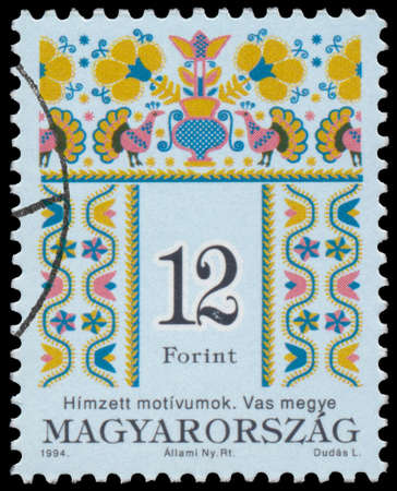BUDAPEST, HUNGARY - 02 FEBRUARY 2015: A stamp printed in Hungary shows Folk motives of Vas county, Hungarian Folk Art serie - circa 1994のeditorial素材