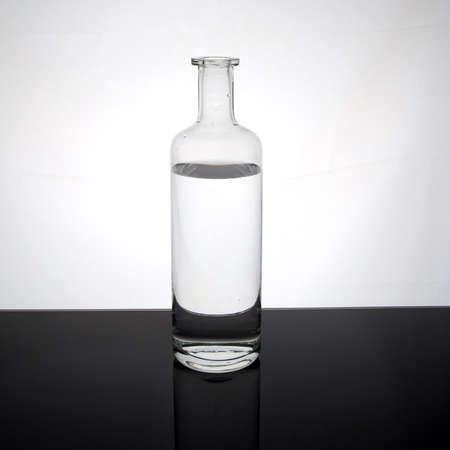Water in a glass bottle on dark surfaceの写真素材