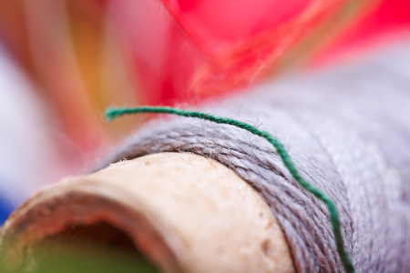 multicolored threads for sewing, as a background