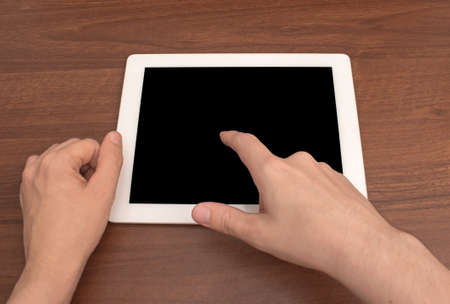 Digital tablet on wooden tablets gesture controlの写真素材