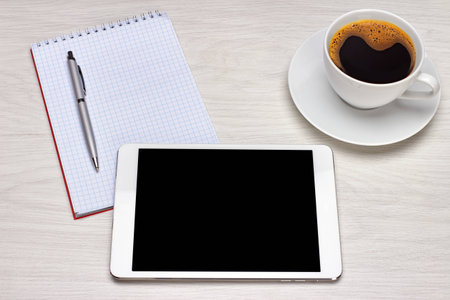 Workplace with tablet and keyboard, pen, coffeeの写真素材
