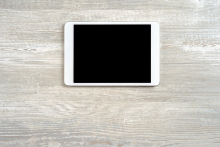White digital tablet on wooden tableの写真素材
