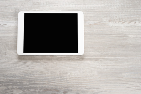 White digital tablet on wooden tableの写真素材