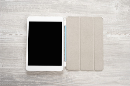 White digital tablet on wooden table