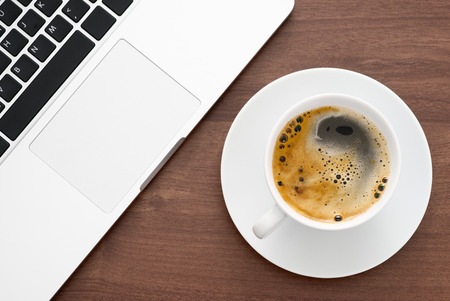 Laptop and coffee top viewの写真素材