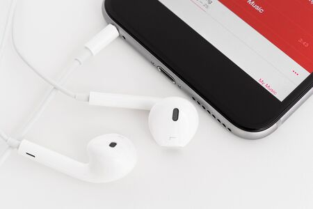 Smartphone with headphones on a white background