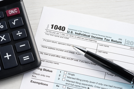 Tax return blank, calculator and penの写真素材