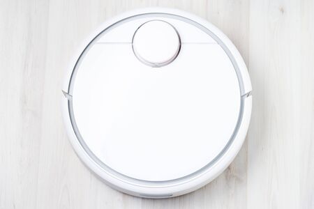 Robot vacuum cleaner, close-up on white light floorの写真素材