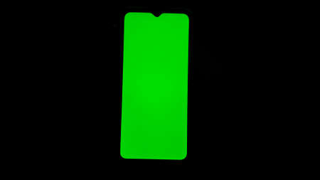 Chroma key on electronic devices, phone and monitor, green screen and hand scrolling through the...