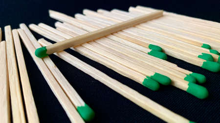 Wooden matches for ignition that have fallen out of the box are lying on the tableの写真素材