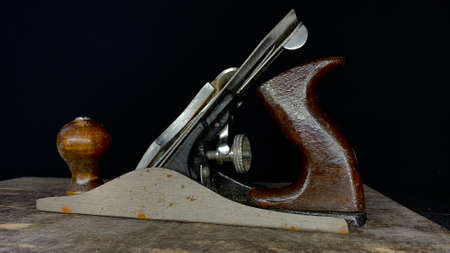 Old glider in the carpentry workshop on the table. Retro tool in use for over 20 years
