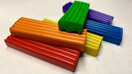 Children's set of colored plastic for development. Pieces of rainbow plastic for children on the tableの写真素材