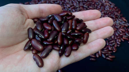 Red beans scattered on a black table