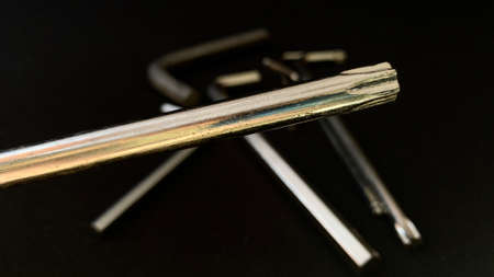 Chrome tools hex wrench for construction work with medel and machines lie on a black backgroundの写真素材