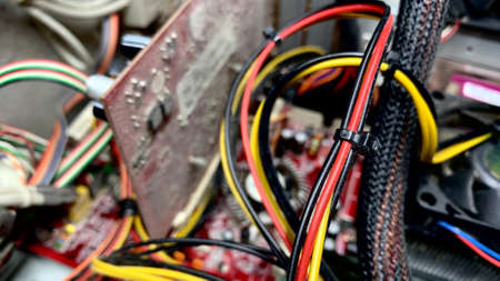 An old computer covered with dust is dismantled in a workshop for fixing broken equipmentの写真素材