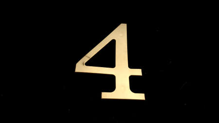 Gold numbers on a black background symbolize a date or designate somethingの写真素材
