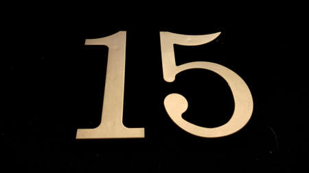 Gold numbers on a black background symbolize a date or designate somethingの写真素材