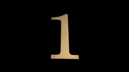 Gold numbers on a black background symbolize a date or designate something