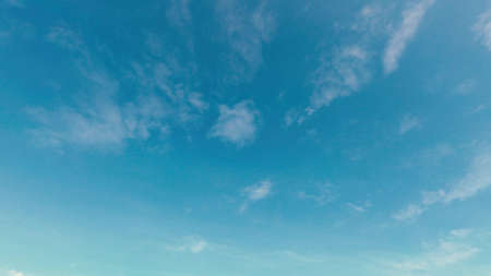 Blue clear sky with air clouds on a very sunny dayの写真素材