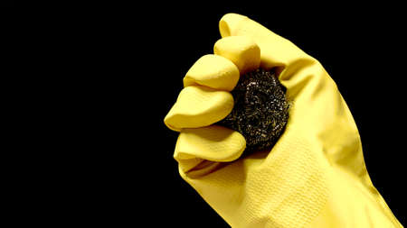 Woman in rubber cleaning gloves prepares to clean up her house using sponges, rags and cleaning productsの写真素材