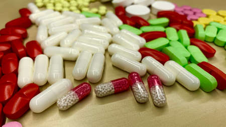 Set of pain medication pills in different colors. Vaccine and antidote in bright capsules