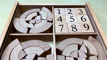 Children's educational game made of natural wood for teaching geometric shapes, counting and...