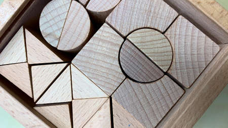 Children's educational game made of natural wood for teaching geometric shapes, counting and improving fine motor skillsの写真素材