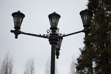 Decorative black lantern to illuminate the park for people walkingの写真素材