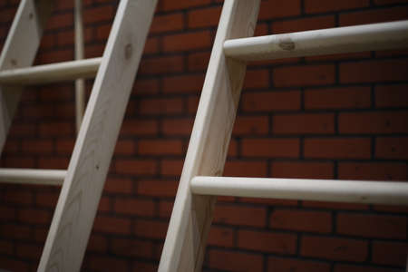 Wooden stairs on a brick background without varnishing, pure untreated wood for building a houseの写真素材