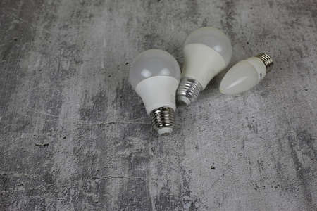 Diode light bulbs on a white background. Light bulbs of different shapes lie on the table