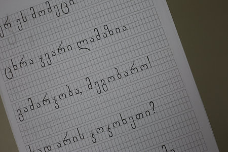 Georgian letters for learning to write to children at school, copybook for learning the Georgian language, white paper with black lettersの写真素材