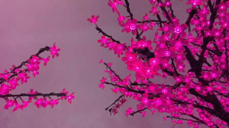 The decoration in the form of a flowering tree glows. Purple leaves with LED.の写真素材