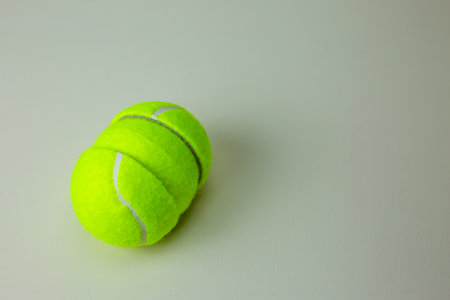 Tennis ball cut in half. The hemisphere of a rubber ball for sports is divided into two parts and a...